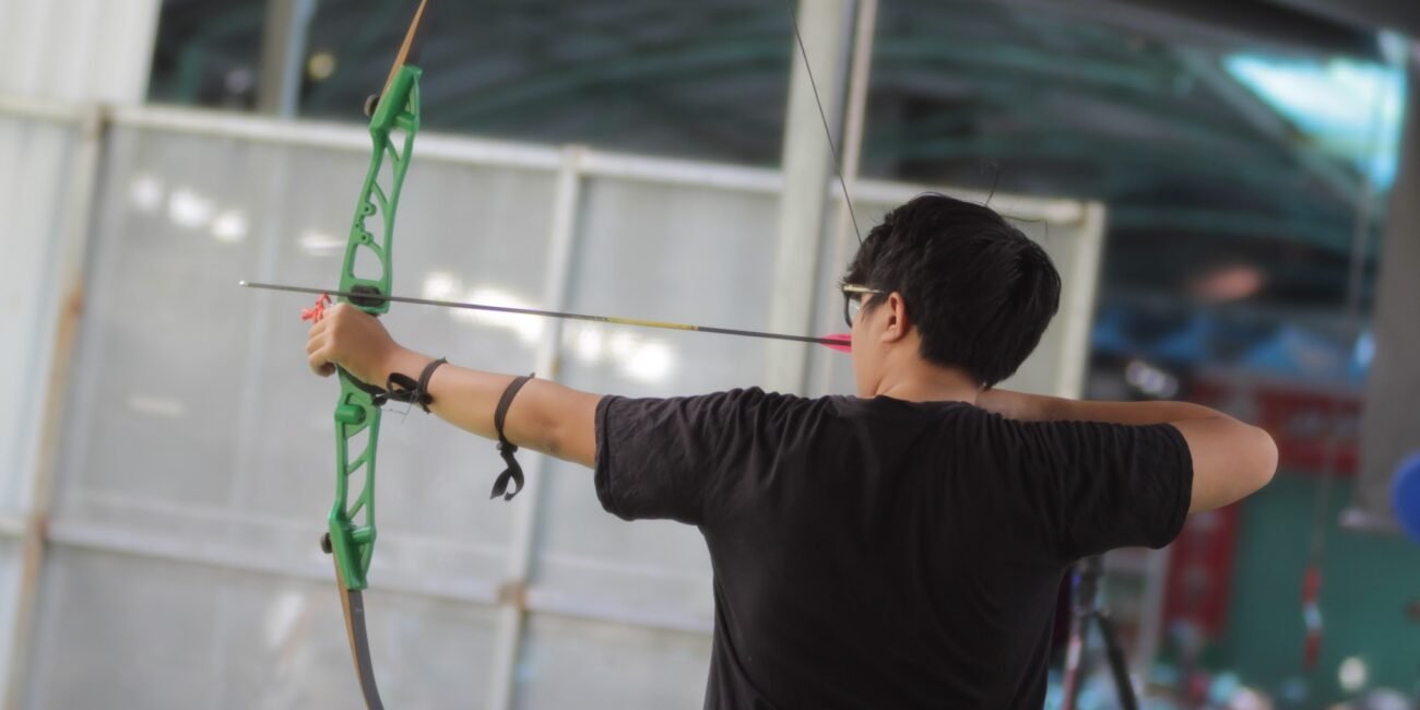 a man using and shooting a basic recurve barebow