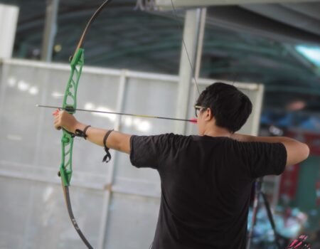 a man using and shooting a basic recurve barebow